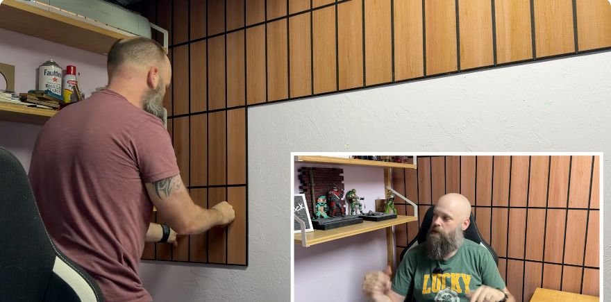 Pressing an adhesive acoustic panel onto a painted textured wall