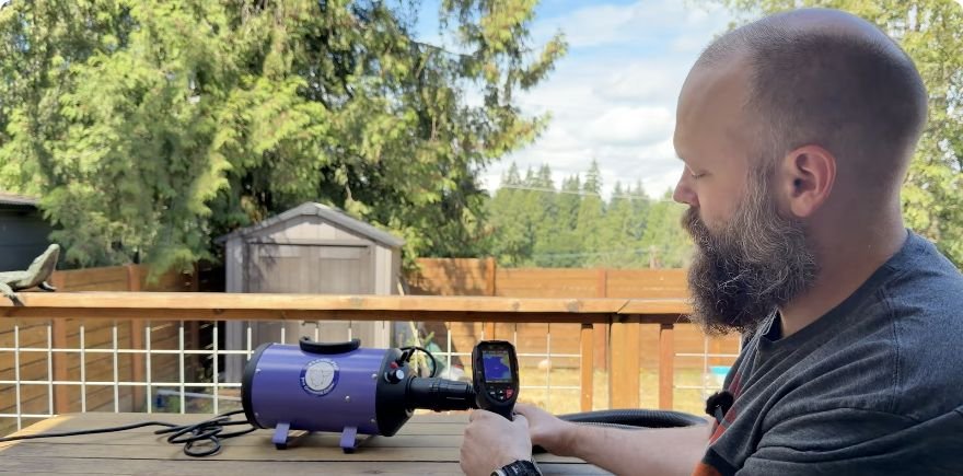 Braden using a handheld thermal camera during the Flying Pig dryer heat test