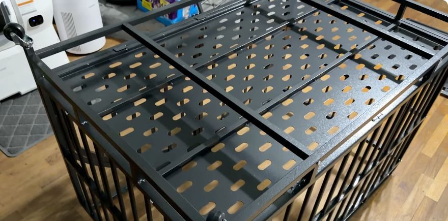 Dog crate turned upside down showing the lower support bars and caster wheels