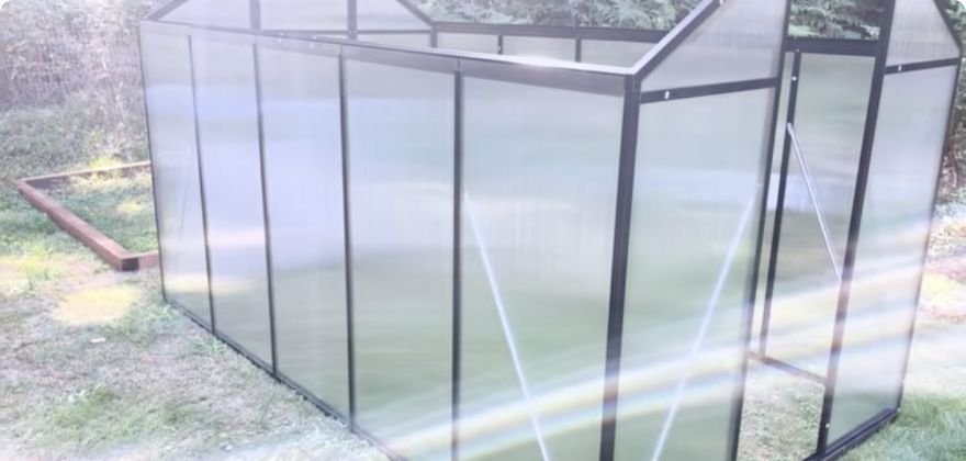 Garvee Life 6x10 greenhouse with side panels fitted during backyard assembly