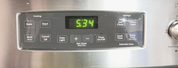 GE oven control panel showing Bake, Start, Cook Time, and Delay Time buttons.